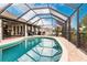 Relaxing screened pool with a large deck and lush landscaping at 301 Gold Tree, Punta Gorda, FL 33955