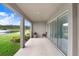 Covered patio with lake view, grill, and seating at 33443 Landsman Loop, Wesley Chapel, FL 33543