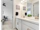 Double vanity bathroom with modern fixtures and a view of bedroom at 33443 Landsman Loop, Wesley Chapel, FL 33543