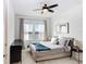 Spacious bedroom with large bed and ceiling fan at 33443 Landsman Loop, Wesley Chapel, FL 33543
