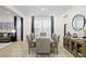 Dining room with large table, gray chairs, and sideboard at 33443 Landsman Loop, Wesley Chapel, FL 33543
