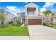 Two-story house with a brown garage door at 33443 Landsman Loop, Wesley Chapel, FL 33543