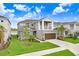 Two-story house with brown garage door and a landscaped yard at 33443 Landsman Loop, Wesley Chapel, FL 33543