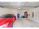 Garage with Tesla and storage shelving at 33443 Landsman Loop, Wesley Chapel, FL 33543