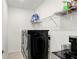 Bright laundry room with washer, dryer, and ample shelving at 33443 Landsman Loop, Wesley Chapel, FL 33543