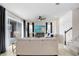 Living room with sliding doors to patio, large TV, and ceiling fan at 33443 Landsman Loop, Wesley Chapel, FL 33543