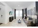 Living room features gray couch and large TV at 33443 Landsman Loop, Wesley Chapel, FL 33543
