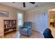 Relaxing bedroom with recliner, bookshelves, and good natural light at 36 Santarem Cir, Punta Gorda, FL 33983