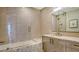 Bathroom with soaking tub and modern vanity at 415 L Ambiance Dr # F608, Longboat Key, FL 34228