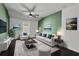 Living room with dark hardwood floors, green accent wall, and comfy seating at 4151 Via Sienna Cir, Sarasota, FL 34243