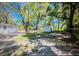 Large backyard with mature trees and a storage shed at 4202 E Richmere St, Tampa, FL 33617