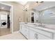 Elegant bathroom with double vanity, large mirror, and walk-in shower at 4611 Trento Pl, Bradenton, FL 34211