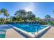 Inviting community pool with ample seating and lush landscaping at 5561 Golf Pointe Dr, Sarasota, FL 34243