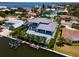 Modern canal-front home with pool, boat dock, and palm trees at 609 Dundee Ln, Holmes Beach, FL 34217