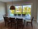 Dining area with table, chairs, and sliding glass doors leading to the patio at 609 Dundee Ln, Holmes Beach, FL 34217