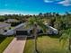 Single-Gathering home with fenced yard, driveway, and palm trees at 6261 Keating Ave, North Port, FL 34291