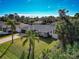 Single-Gathering house with a large yard and palm trees at 6261 Keating Ave, North Port, FL 34291