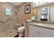 Bathroom features a walk-in shower, granite vanity, and updated fixtures at 6261 Keating Ave, North Port, FL 34291