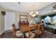 Formal dining room with a wooden table and chandelier, adjacent to living area at 6261 Keating Ave, North Port, FL 34291