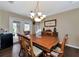 Dining room features a wood table, chandelier, and access to the backyard at 6261 Keating Ave, North Port, FL 34291