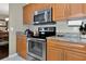Stainless steel appliances and granite countertops in this kitchen at 6261 Keating Ave, North Port, FL 34291