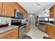 Modern kitchen with stainless steel appliances and granite countertops at 6261 Keating Ave, North Port, FL 34291