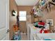 Laundry room with washer, dryer, and ample storage shelving at 6261 Keating Ave, North Port, FL 34291