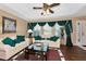 Living room boasts hardwood floors, comfy seating, and green accents at 6261 Keating Ave, North Port, FL 34291