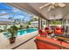 Relaxing pool area with covered patio and wicker furniture at 6261 Keating Ave, North Port, FL 34291