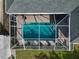 Aerial view of a screened-in rectangular pool in backyard at 6261 Keating Ave, North Port, FL 34291