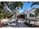 Spacious backyard with palm trees, a hammock, and a flagstone patio at 633 Calle De Peru, Sarasota, FL 34242