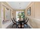 Formal dining room features an oval table and chandelier at 6614 38Th E St, Sarasota, FL 34243