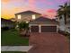 Two-story house with brick driveway and landscaping at 6614 38Th E St, Sarasota, FL 34243