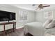 Bright bedroom with a queen bed, large TV, and wood-look floors at 6623 Glades Way, Sarasota, FL 34231