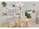 Bright dining room with glass table and view into kitchen and office at 6908 Drewrys Blf # 711, Bradenton, FL 34203