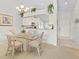 Dining area with glass table and view into kitchen at 6908 Drewrys Blf # 711, Bradenton, FL 34203