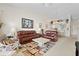 Living room with leather sofas and view into kitchen and dining area at 6908 Drewrys Blf # 711, Bradenton, FL 34203
