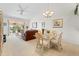 Spacious living room with glass dining table and access to balcony at 6908 Drewrys Blf # 711, Bradenton, FL 34203