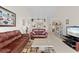 Bright living room with leather sofas, coffee table, and view to kitchen at 6908 Drewrys Blf # 711, Bradenton, FL 34203