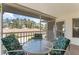 Condo balcony with table and chairs, view of trees at 6908 Drewrys Blf # 711, Bradenton, FL 34203