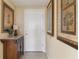 Bright entryway with wood cabinet and framed artwork at 750 N Tamiami Trl # 420, Sarasota, FL 34236