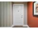 White front door with brass knocker in a condo hallway at 750 N Tamiami Trl # 420, Sarasota, FL 34236