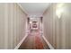 Long hallway with striped wallpaper and patterned carpet at 750 N Tamiami Trl # 420, Sarasota, FL 34236