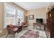 Spacious home office with large windows, comfortable seating, and a desk at 750 N Tamiami Trl # 420, Sarasota, FL 34236