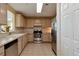 Well-equipped kitchen with stainless steel appliances and light wood cabinets at 750 N Tamiami Trl # 420, Sarasota, FL 34236