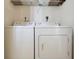 Laundry closet with full-size washer and dryer at 750 N Tamiami Trl # 420, Sarasota, FL 34236