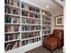 Cozy library featuring built-in bookshelves and a comfortable armchair at 750 N Tamiami Trl # 420, Sarasota, FL 34236