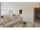 Living room with a sofa, coffee table, and view into dining area at 750 N Tamiami Trl # 420, Sarasota, FL 34236
