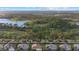 Aerial view of homes and tranquil landscapes near a lake at 7781 Grande Shores Dr, Sarasota, FL 34240