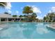 Resort-style pool with lounge chairs and palm trees at 7781 Grande Shores Dr, Sarasota, FL 34240